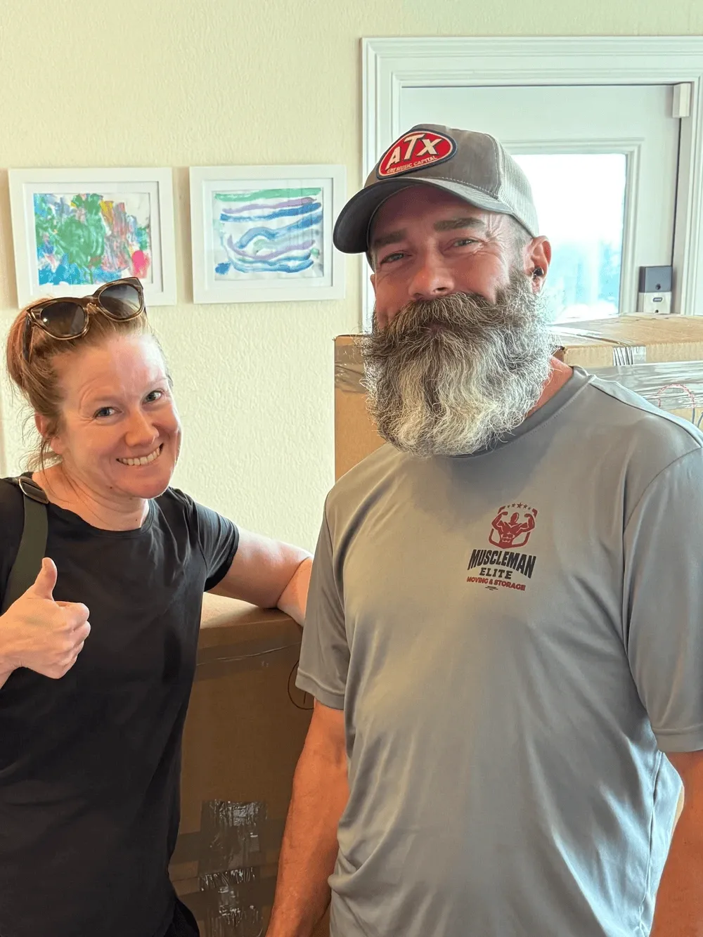 Muscleman Elite crew celebrating a successful move with a happy Austin homeowner