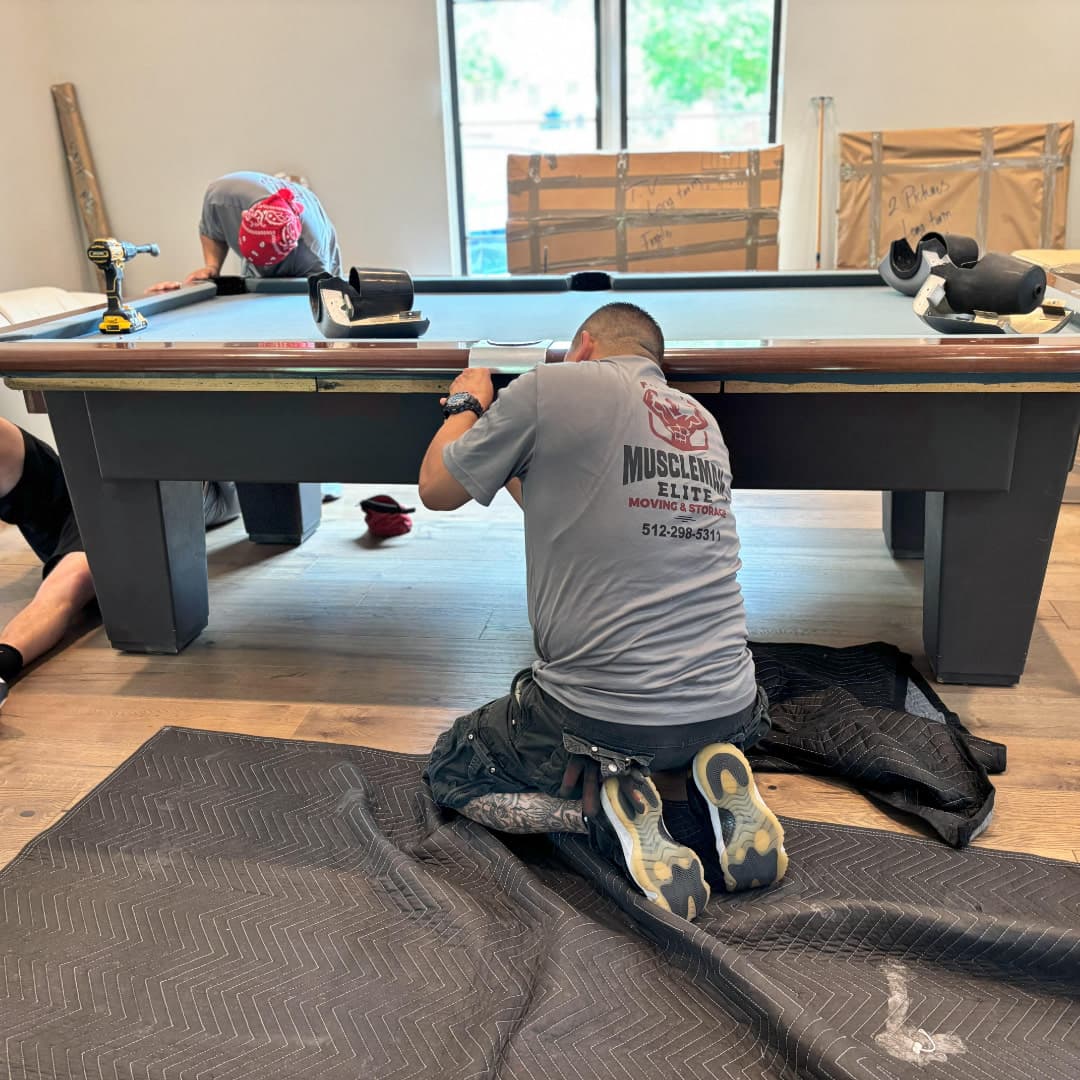 Pool table legs being detached for safe relocation