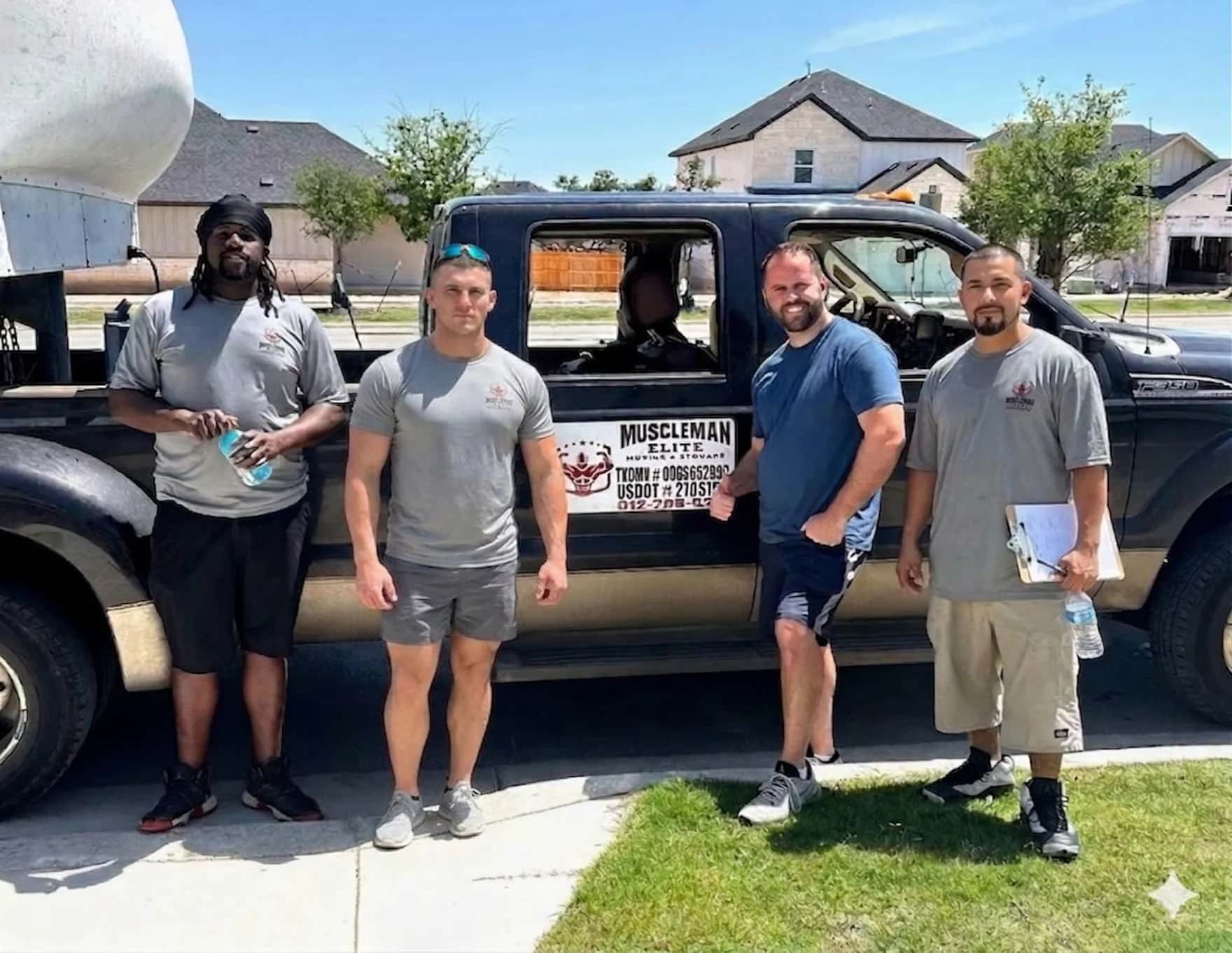 Muscleman Elite Moving crew with happy customer after completing an Austin home move