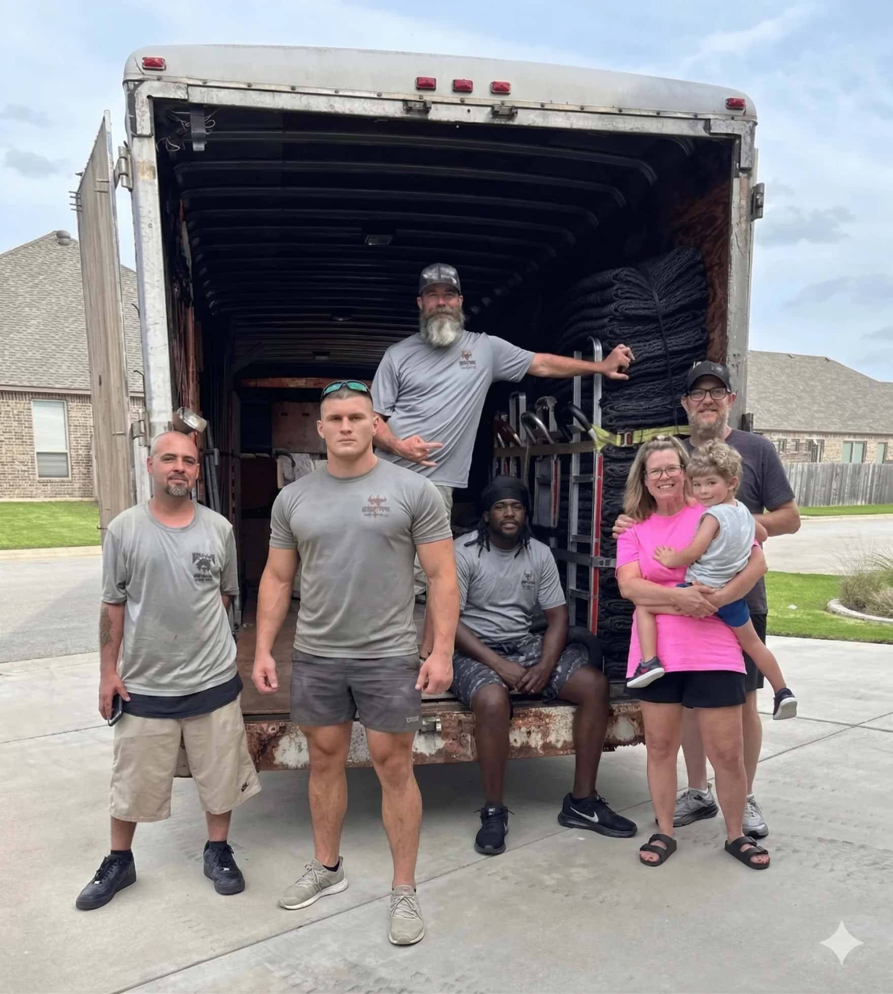 Muscleman Elite Moving crew carefully wrapping furniture during an Austin residential move